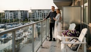 Couple on Friday Harbour condo balcony marina view