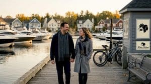 Couple walking at marina promenade sunrise