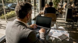 Investor reviewing rental income projection on laptop