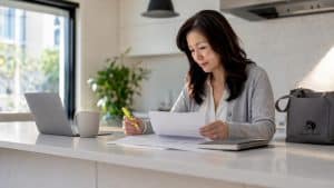 Woman reviewing rental documents at home office