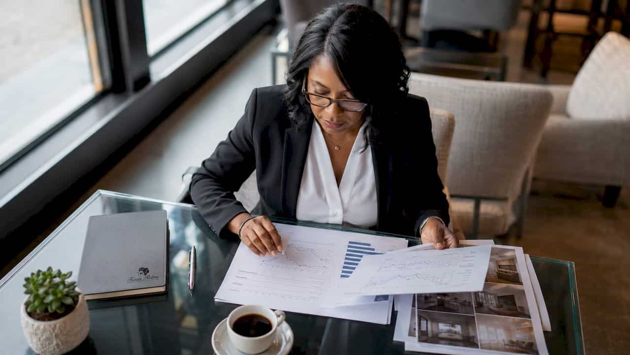 Real estate agent reviewing market timing documents