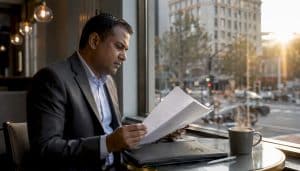 Man reviewing luxury property documents indoors