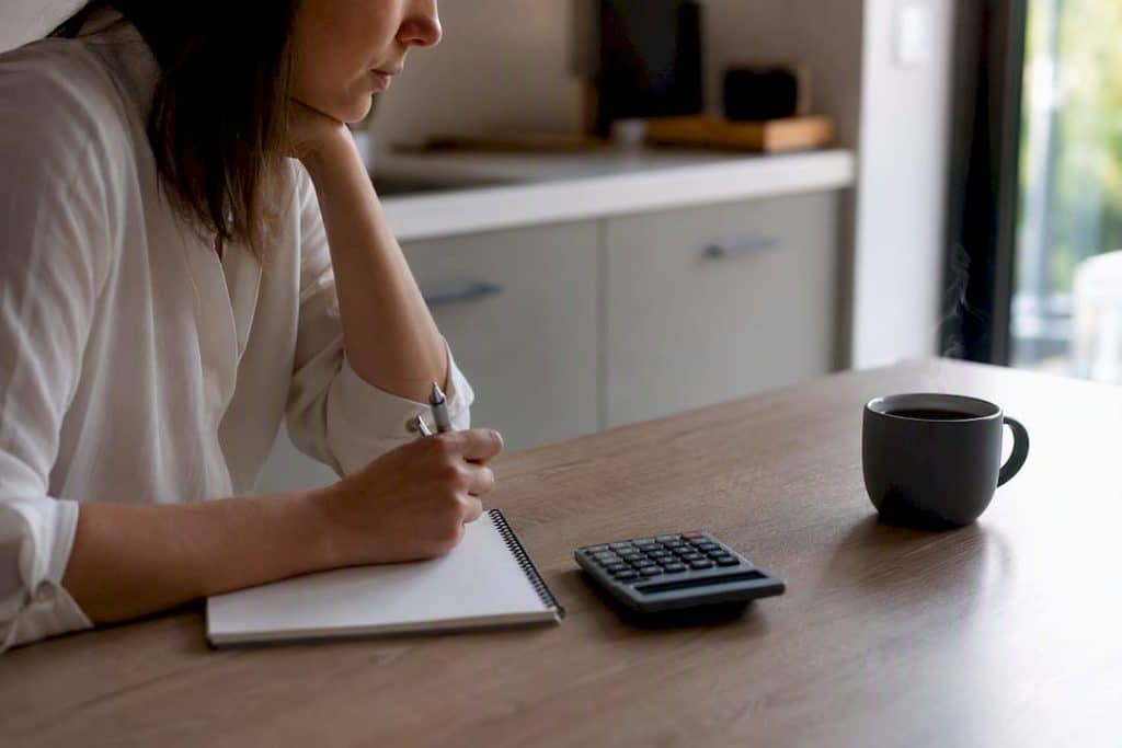 Calculator and paperwork on desk for cash flow