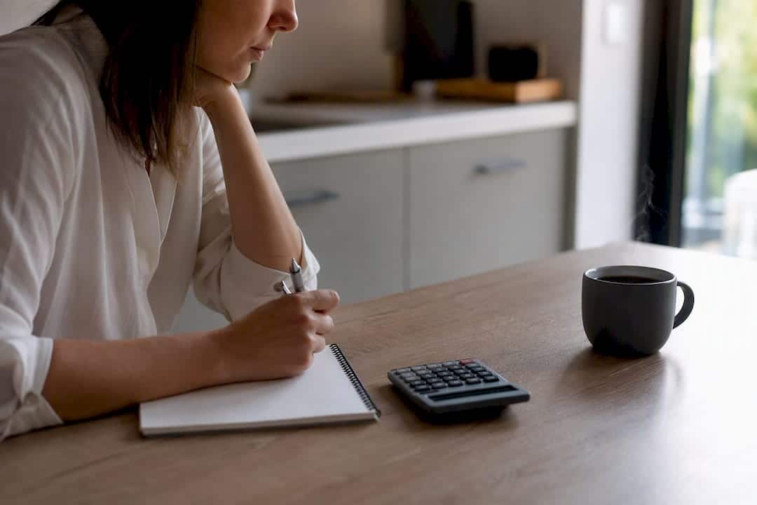 Calculator and paperwork on desk for cash flow