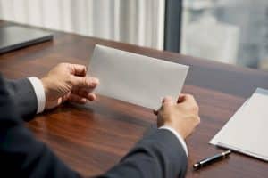 Lawyer holding trust cheque envelope