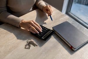 Calculator and property sale records on desk